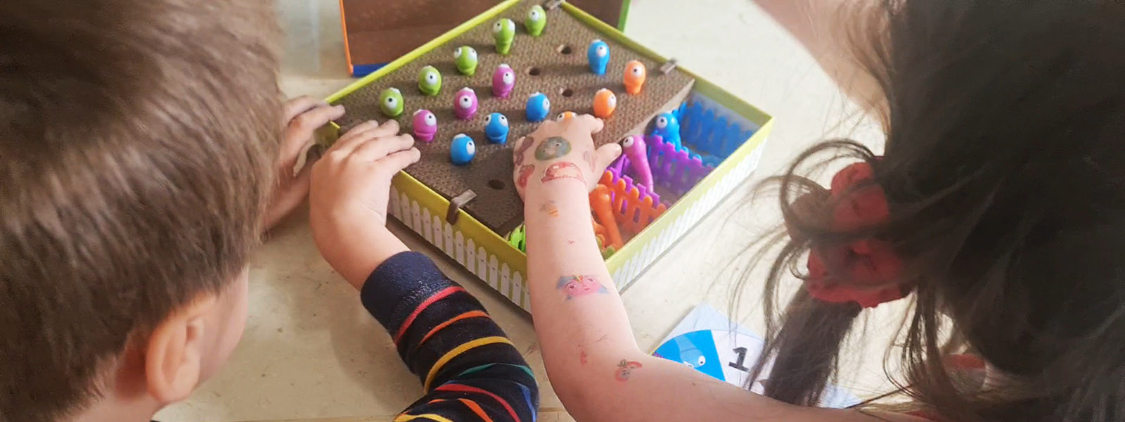 Two children playing with fine motor activity games.