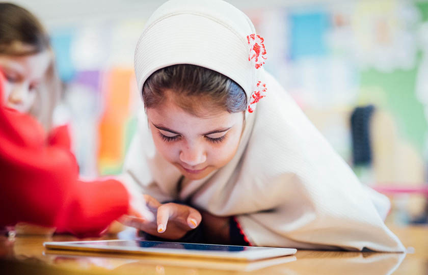 Primary School student playing on tablet device