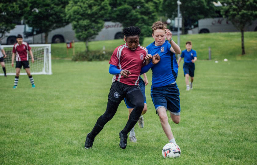 CBS students jostle for the ball.